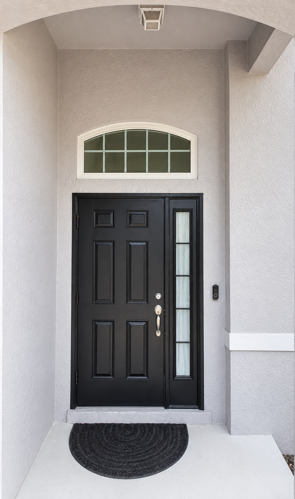 Black impact entry door with sidelight and arched transom